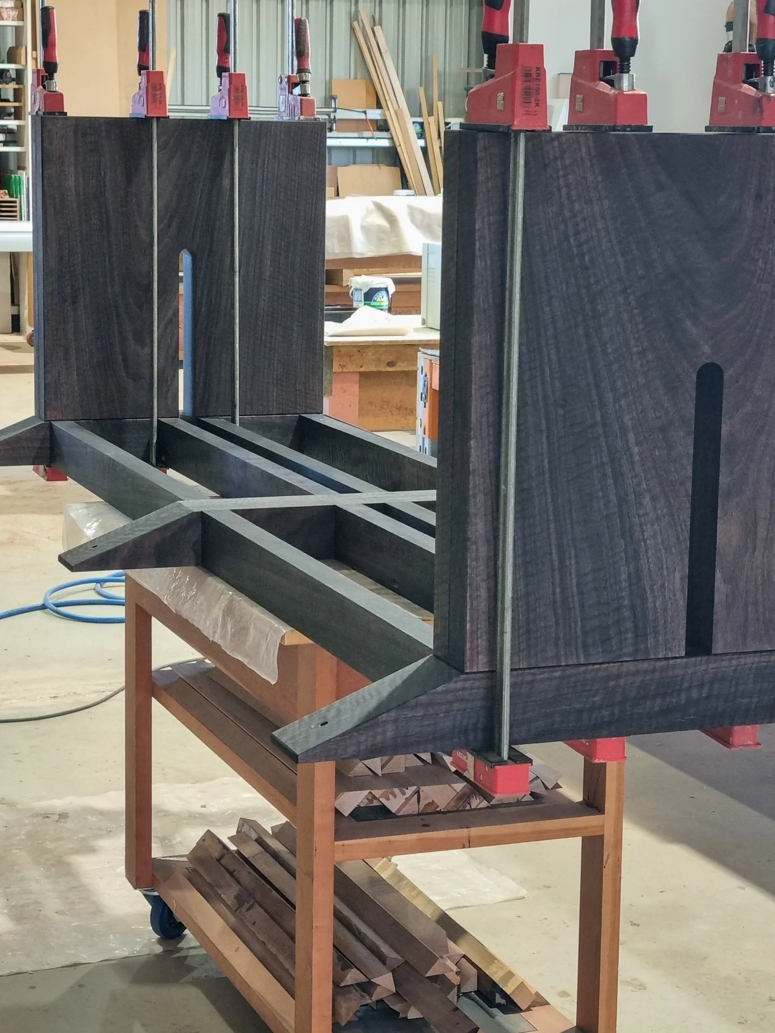Dark fluted timber panels resting on a workshop trolley, staged for assembly at Nathan Day Design