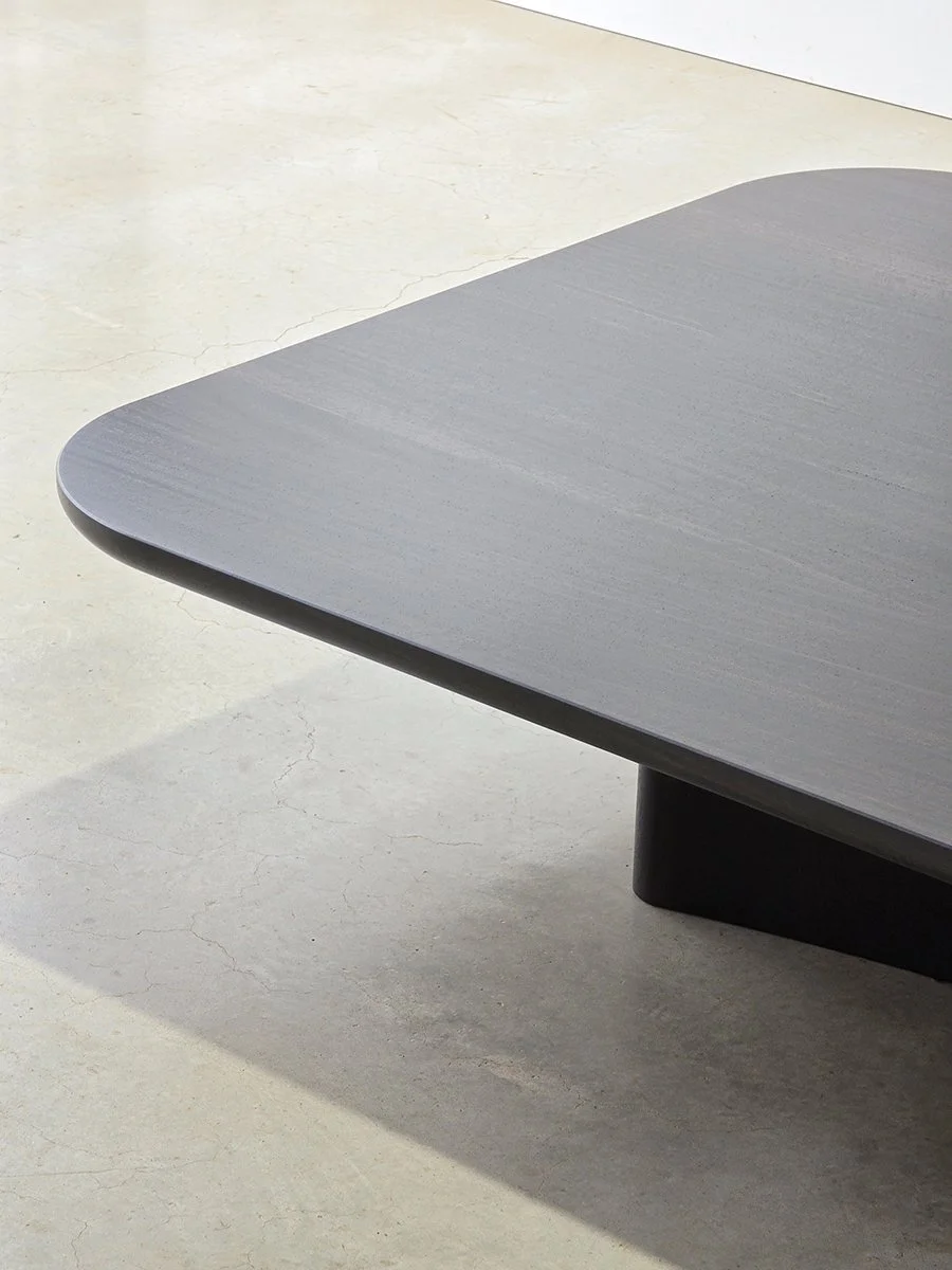 Corner detail of the Prehistoric Coffee Table's curved timber base in ebonised jarrah - bespoke furniture maker Nathan Day Design