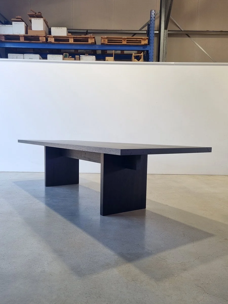 Angled view of a Como Table section in ancient Jarrah with matching flat slab legs - Nathan Day Design