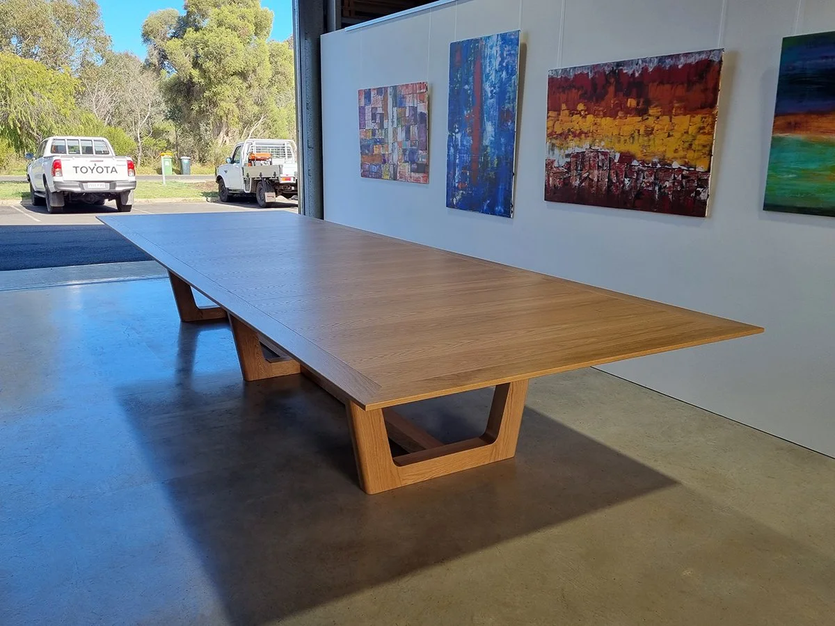 Rhodes House Boardroom Table in American Oak, trestle base design - Nathan Day Design, corner angled view showing trestle base joinery detail