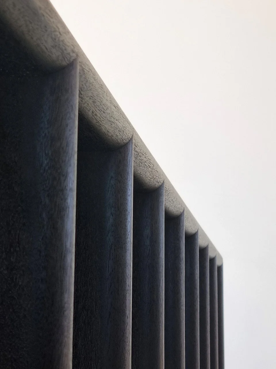 Millipede Console in ebonised Jarrah, close-up angled view of fin legs - Nathan Day Design