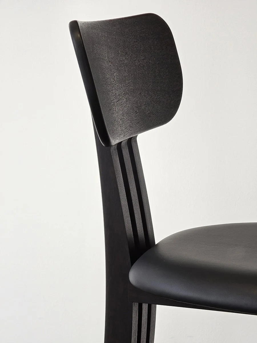 Tulip Chair in ebonised Jarrah with vertical slat back and black upholstered seat, close-up angled view - bespoke furniture by Nathan Day Design