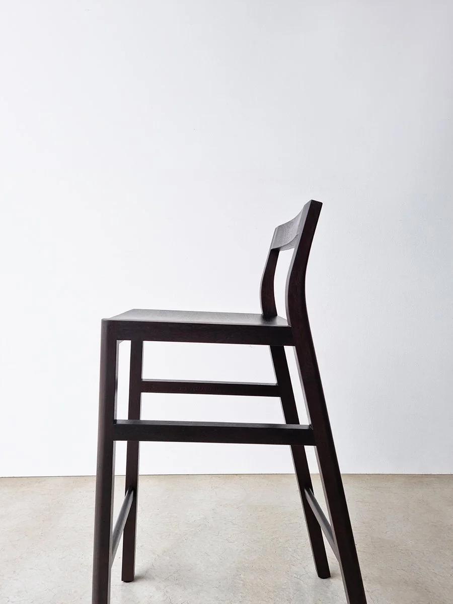 Low-back Bar Stool in ebonised Jarrah, front-angle view in plain studio setting - Nathan Day Design