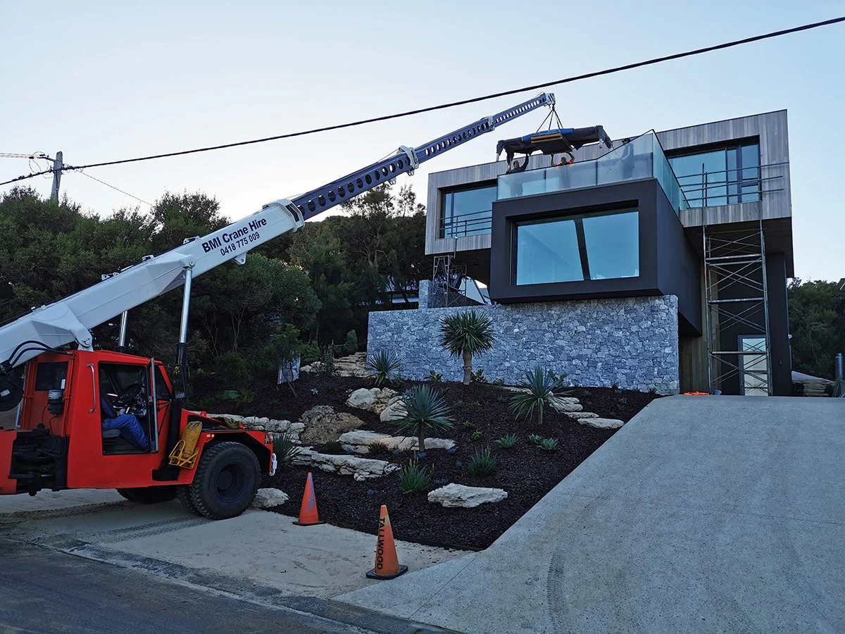 Wardanup Outdoor Table in American Oak - Nathan Day Design, on-site installation shot with mobile crane delivery