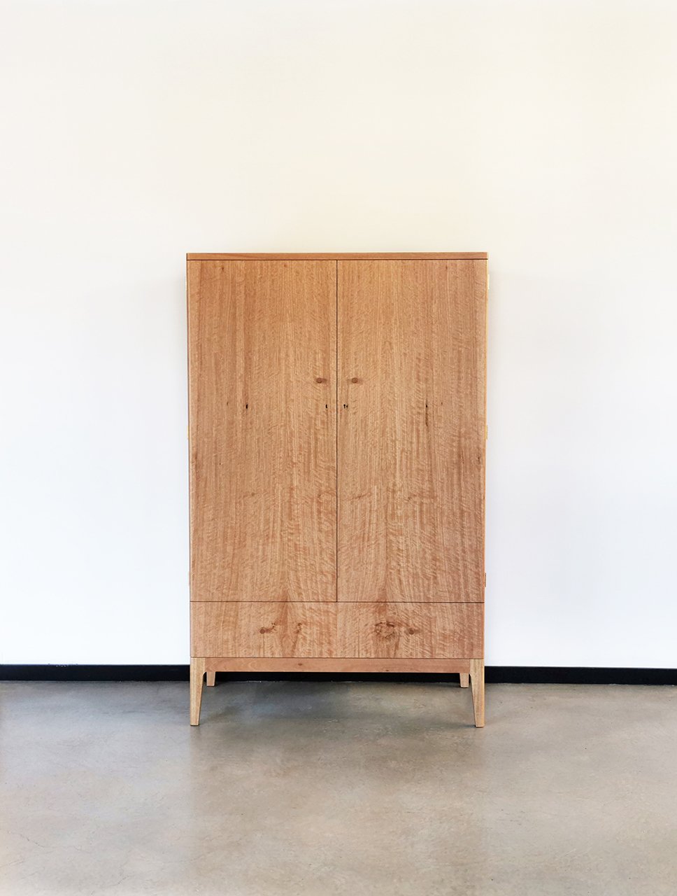 Gifford Rd Cabinet in WA Blackbutt, full front view with closed doors in plain studio setting - Nathan Day Design