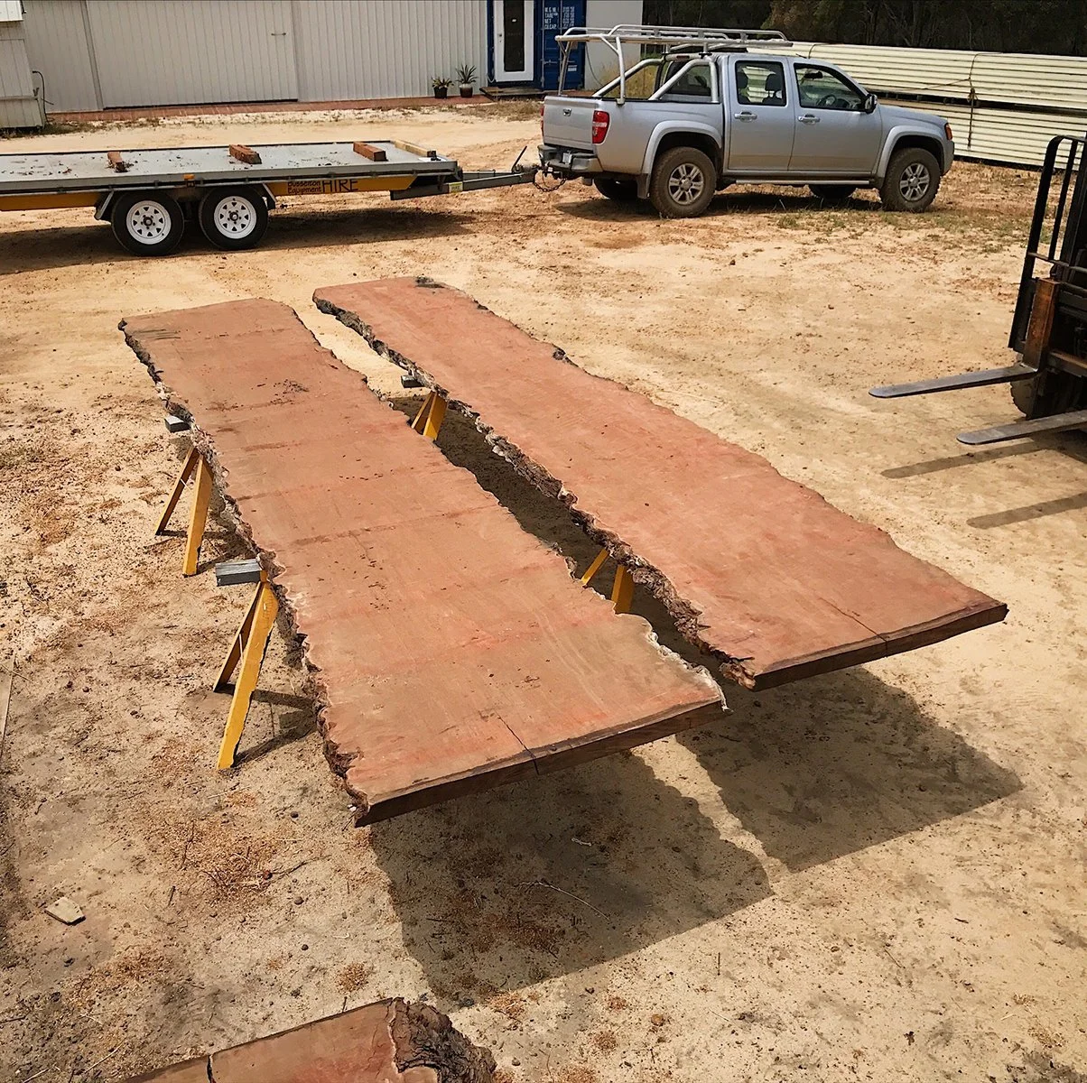 Clairault Outdoor Table in ebonised Jarrah - Nathan Day Design, raw Jarrah timber slabs delivery on trestles