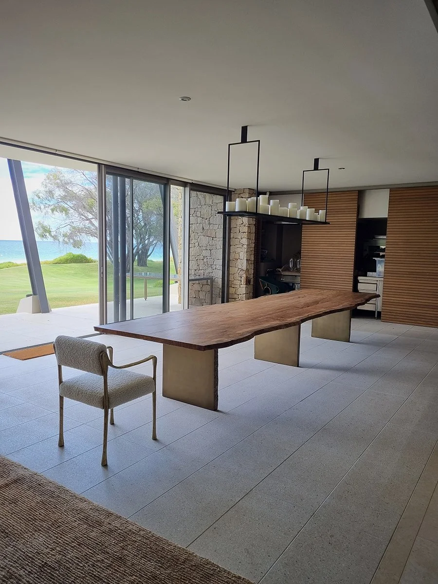 Live edge dining table styled in a coastal home with ocean views, pendant lighting and stone feature wall - bespoke furniture by Nathan Day Design