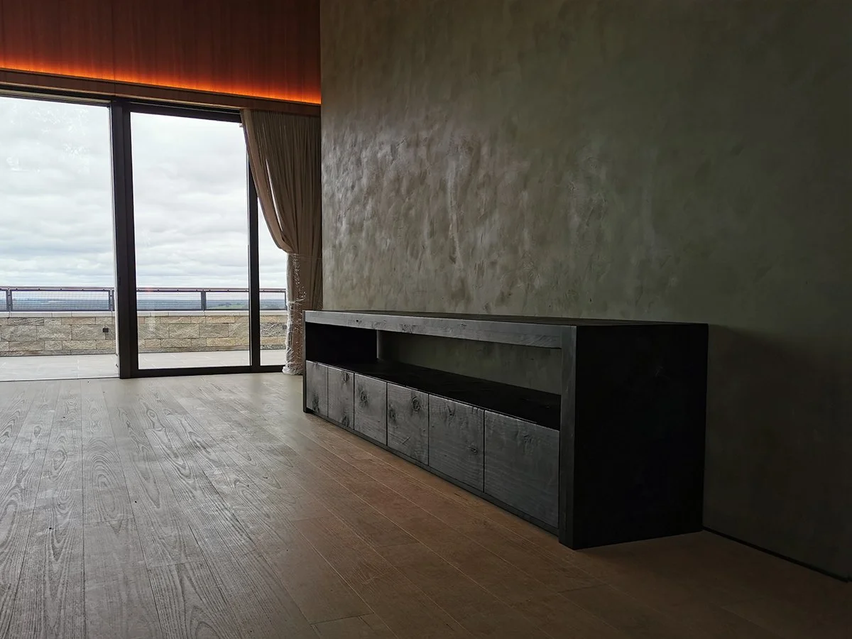 Scorched Buffet in scorched Norfolk Island Pine, wide view in ocean-facing living room - Nathan Day Design