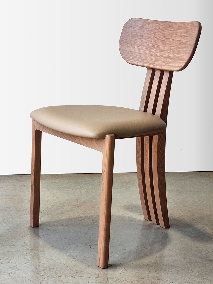 Tulip Chair in American Oak with tan leather seat, low angled side view showing curved seat pan and slender oak leg - bespoke furniture by Nathan Day Design