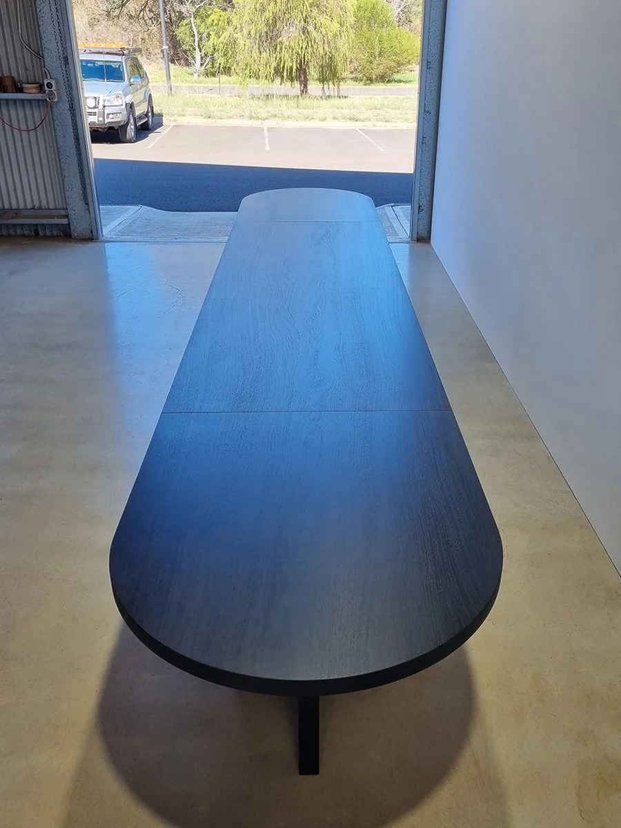 Overhead view down the full length of the Como Table's seamless single-slab Jarrah top - Nathan Day Design