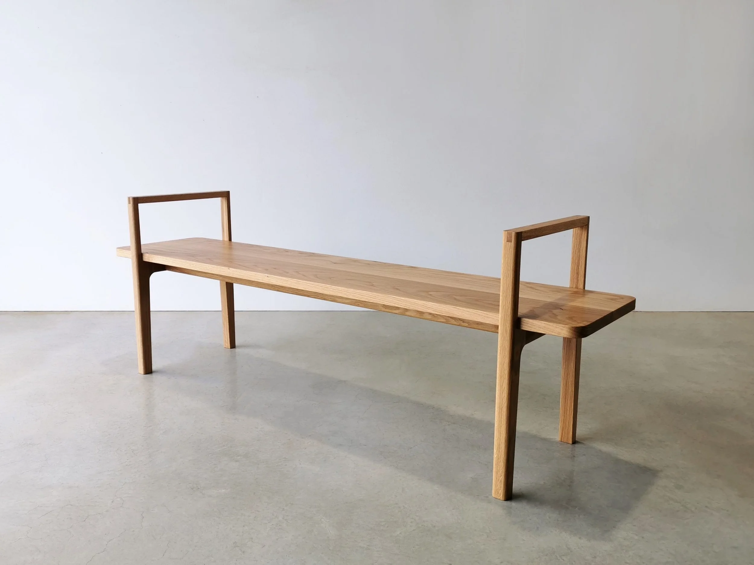Mel Bench in American Oak, Nathan Day Design bespoke furniture - full side view in plain studio setting