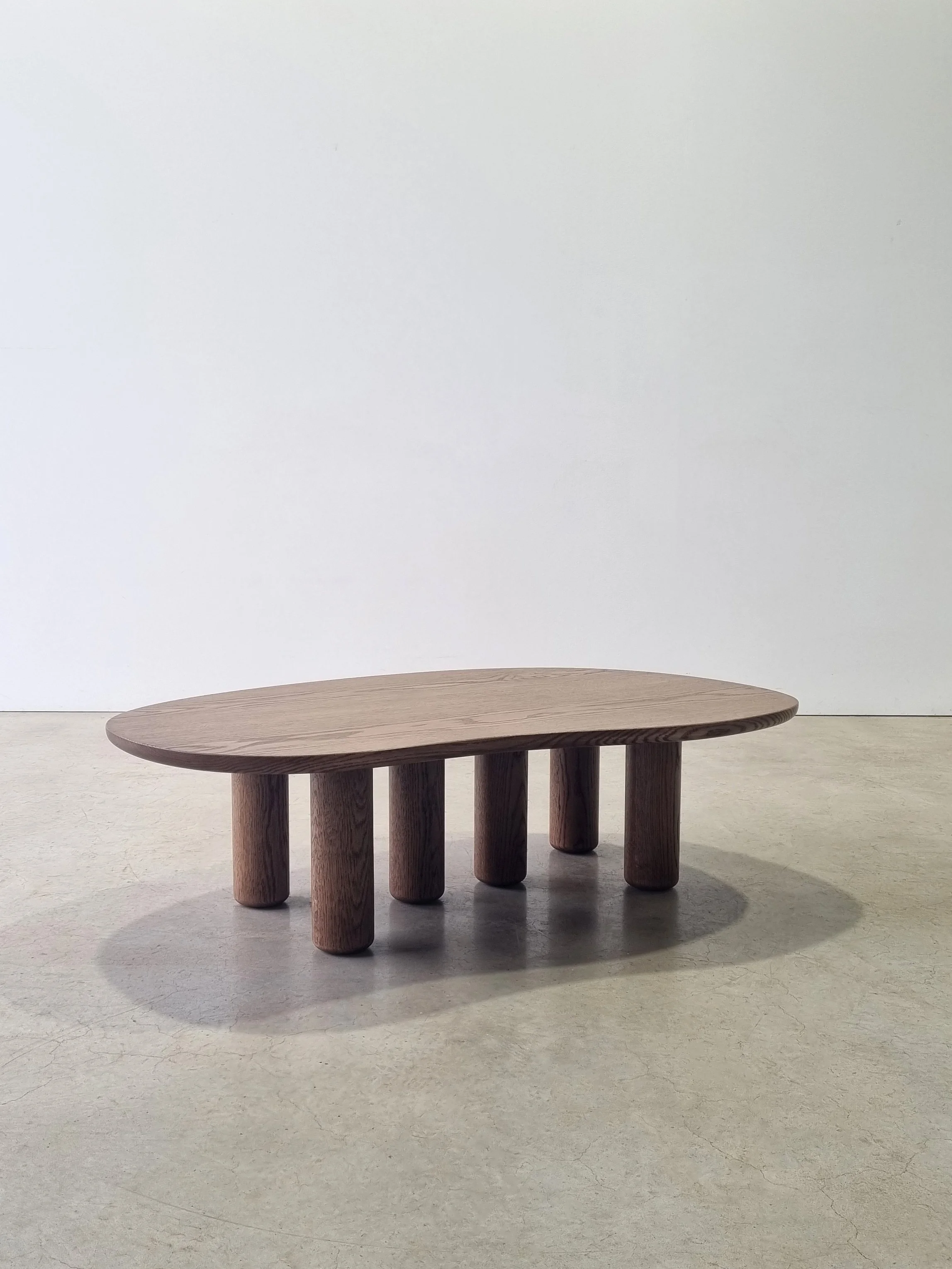 Anemone coffee table with organic kidney-bean shaped top in tinted American Oak and matching column legs - Nathan Day Design