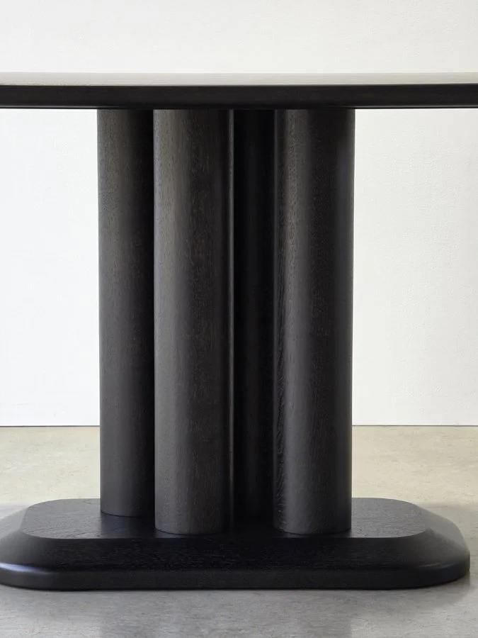 Front-on view of the Coop Nook Table's offset leg trio, the signature visual illusion of the design - Nathan Day Design