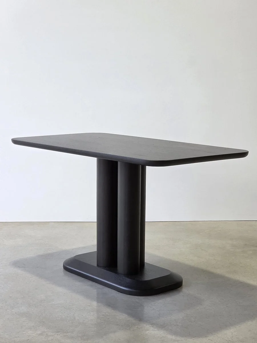 Angled view of the Coop Nook Table, offset legs creating the illusion of a single column - Nathan Day Design