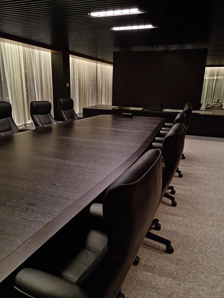 Walters Drive Boardroom Table in ebonised Walnut - Nathan Day Design, long side view down length of table in moody lighting