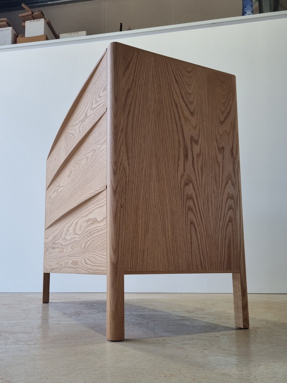 Hampden Chest of Drawers in American Oak - Nathan Day Design, angled rear view showing leg and frame construction