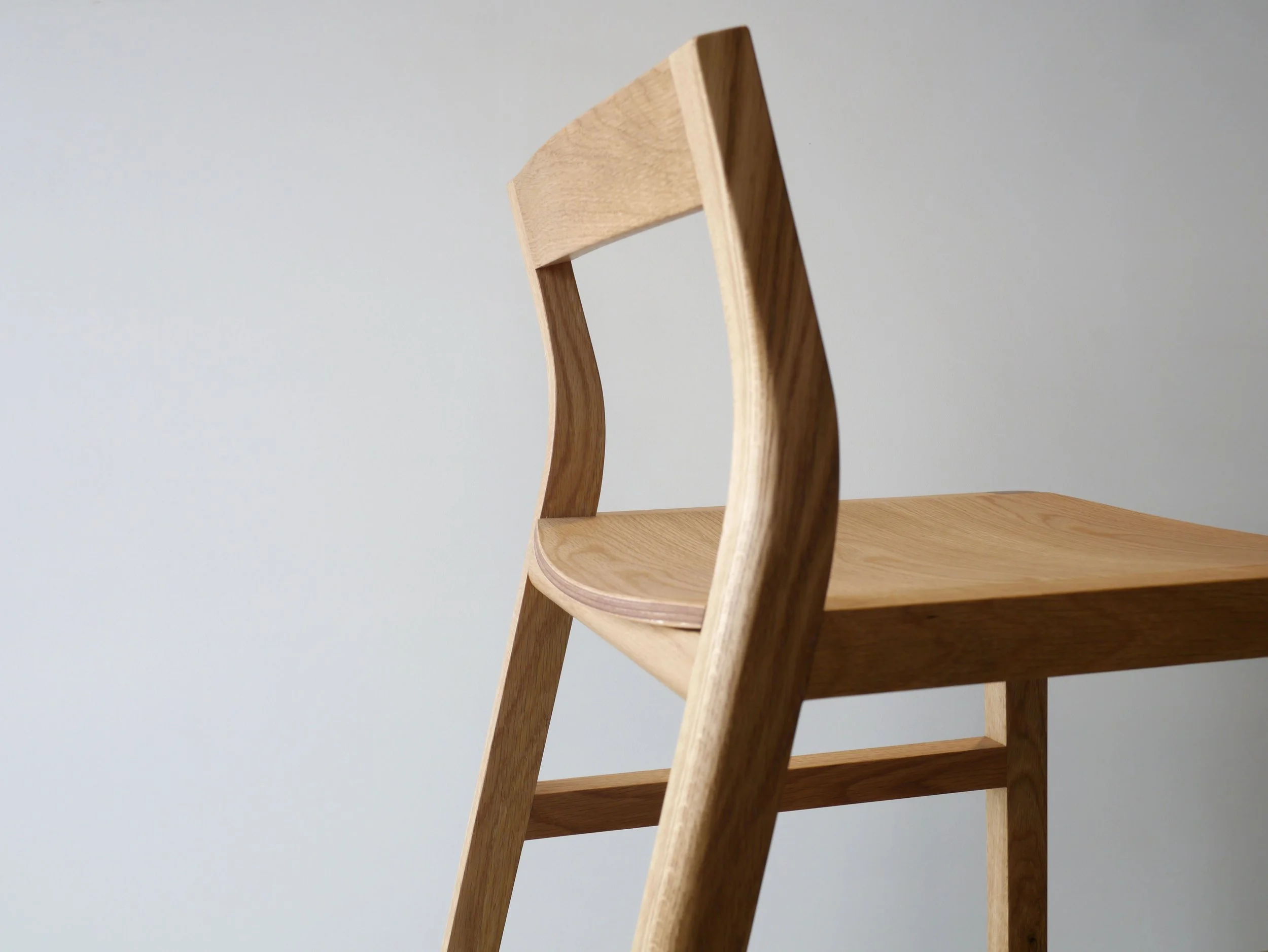 Low-back Bar Stool in American Oak, natural timber variant, full view in plain studio setting - Nathan Day Design