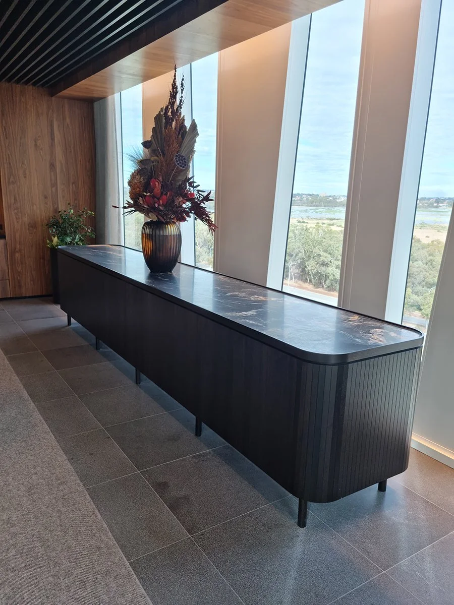 Walters Boardroom Credenza in ebonised American Walnut, alternate angle in boardroom with styled vase - Nathan Day Design
