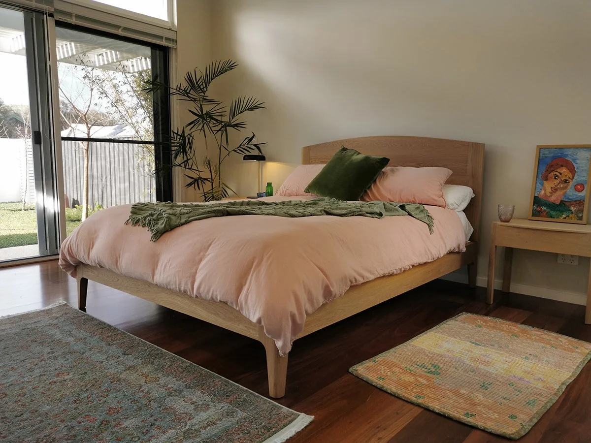 Quindalup Bed in American Oak - Nathan Day Design, bedroom lifestyle shot beside sliding glass door