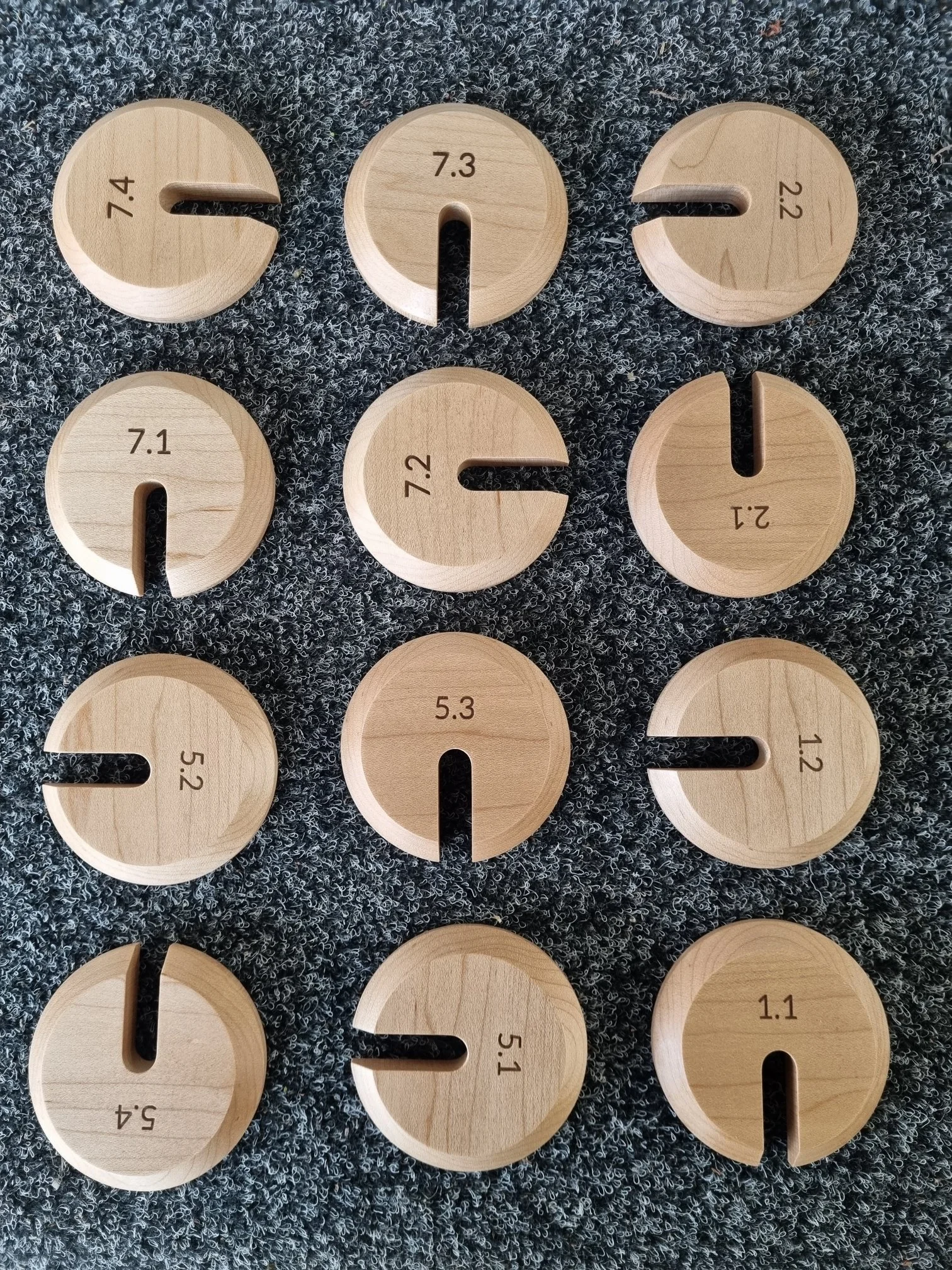 Numbered round timber offcuts used for tracking and matching material during production at Nathan Day Design