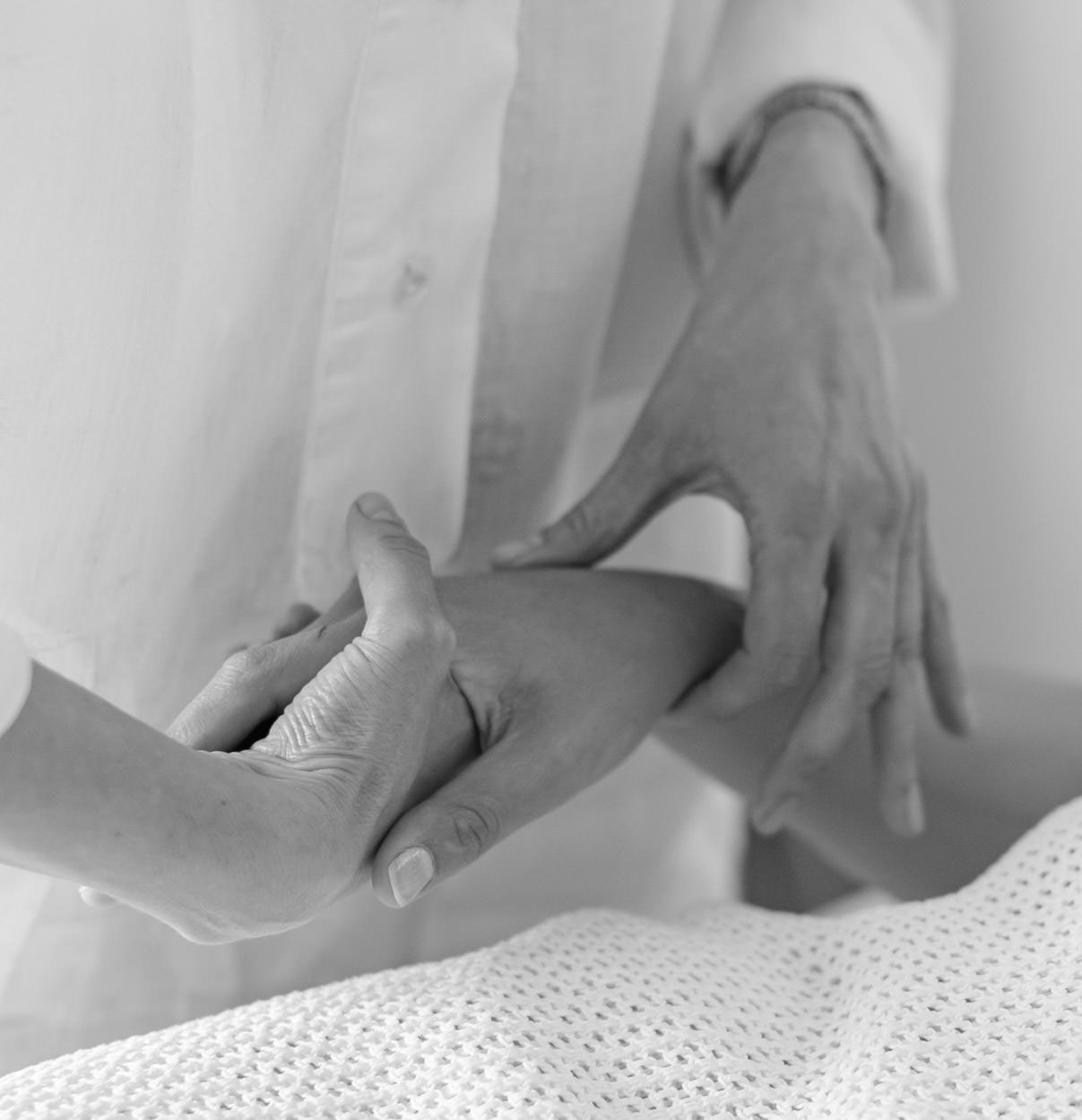 An acupuncturist taking the pulse of a patient