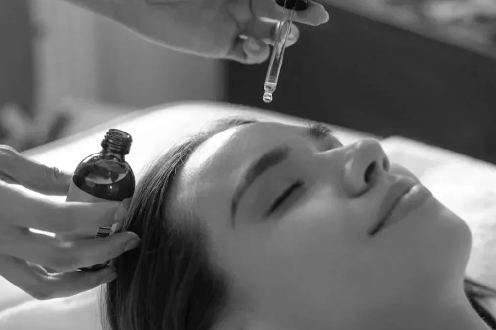 A woman lying down receiving a EIM™ Facial Gua sha
