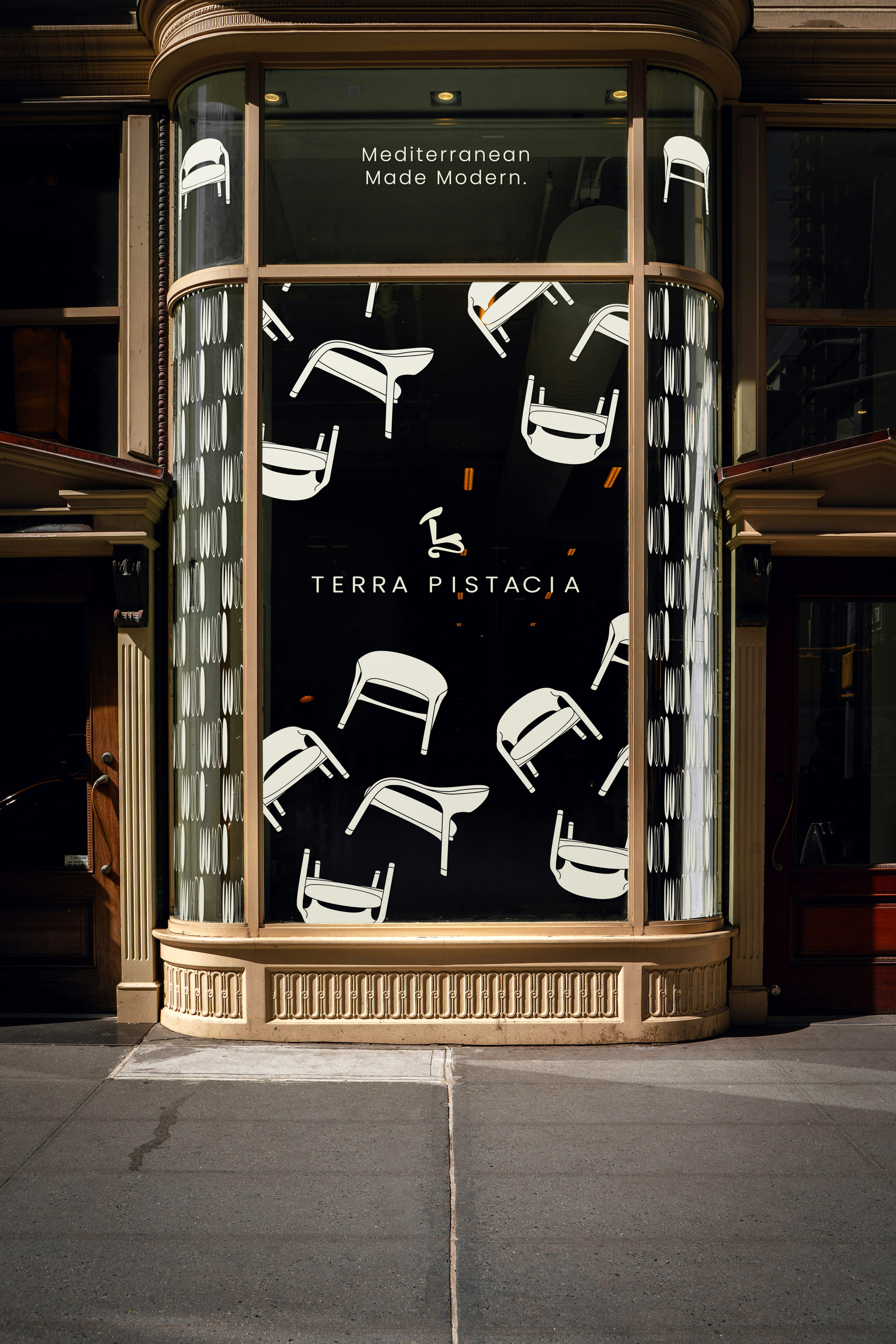 Storefront window with the text 'Mediterranean Made Modern' and 'TERRA PISTACIA,' decorated with illustrations of modern chairs.