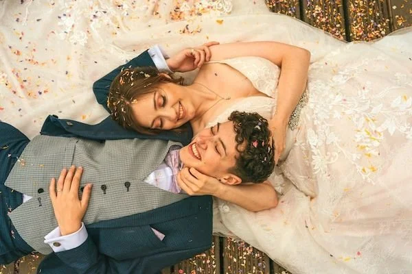 Fairyhill wedding couple in South Wales.Two happy brides just married, laying on their backs cuddling, wedding shot taken by a drone from above. Two brides just after their wedding ceremony, at Fairyhill in Swansea.