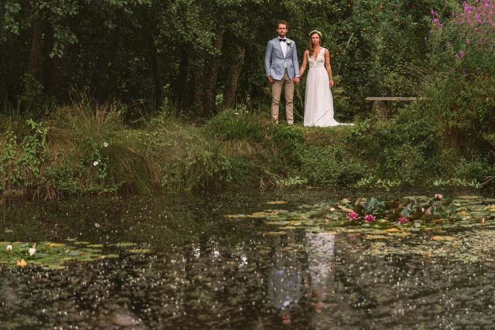Bride and groom lake reflection