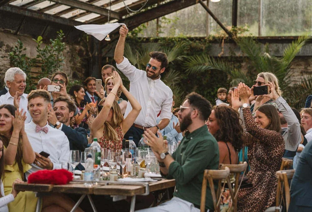 Cheering guests during wedding breakfast