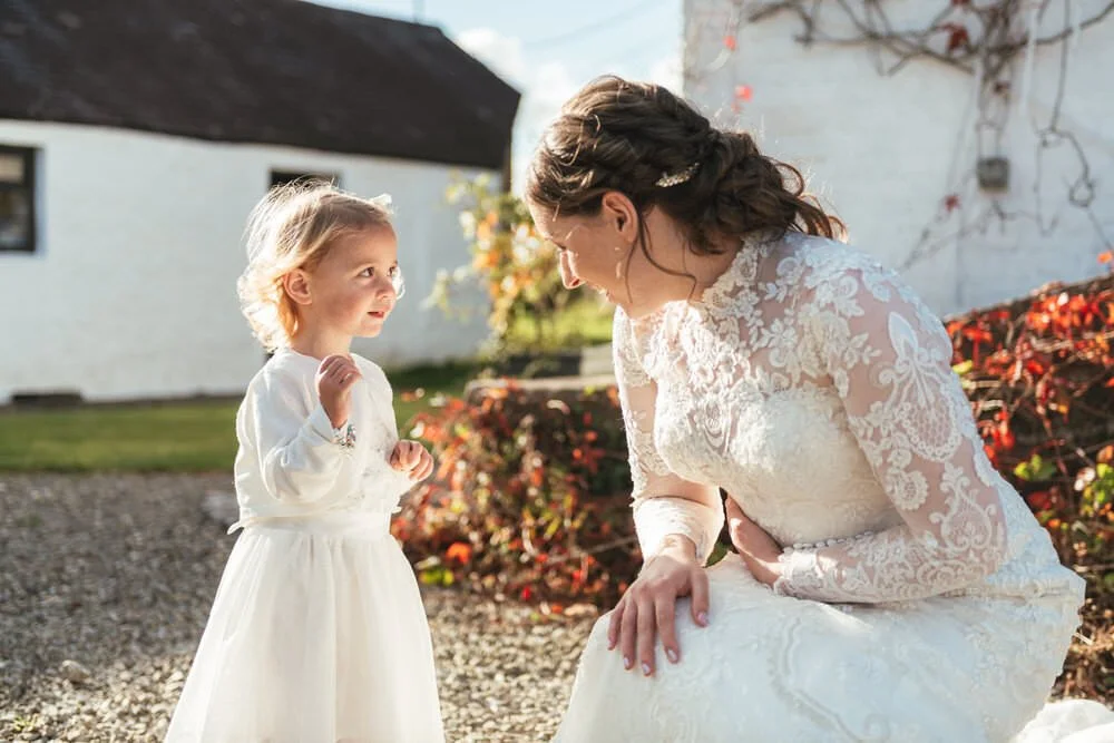 Bride talking to flower girl