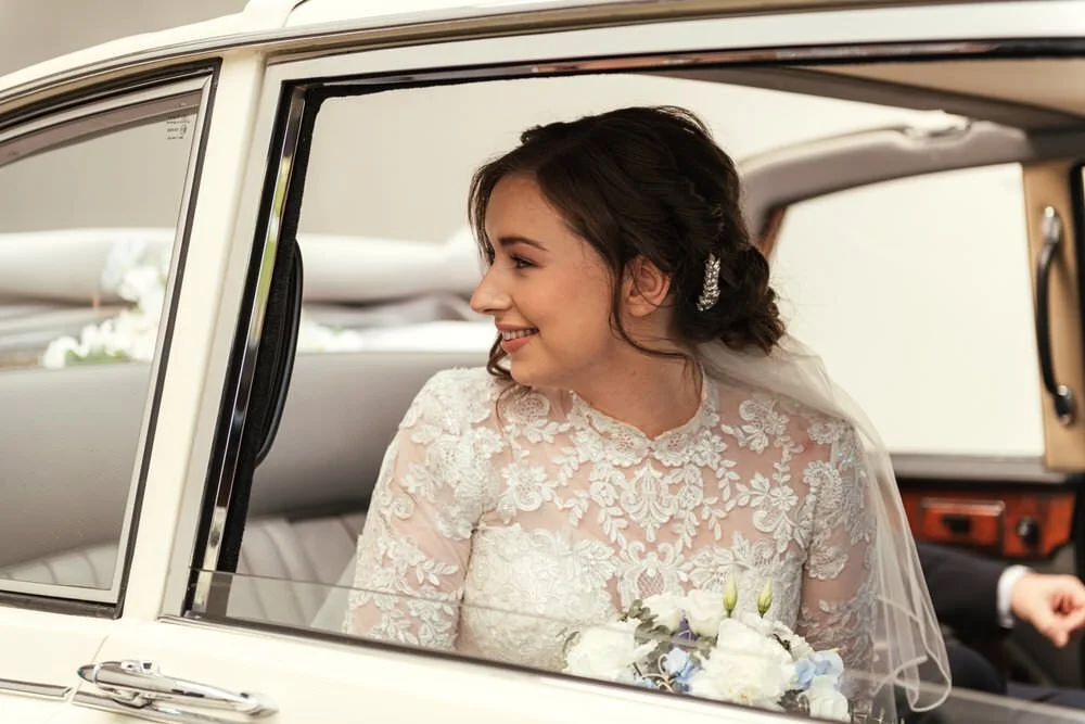 Bride looking out of wedding car