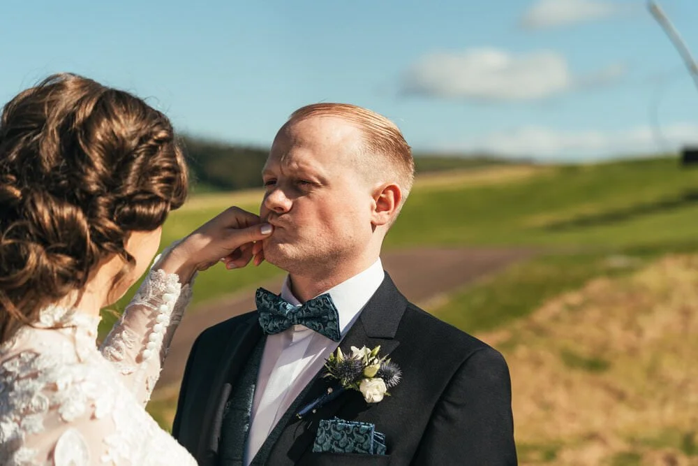 Bride wiping liptstick off groom