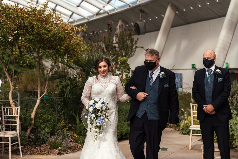 Bride walking down aisle with dad