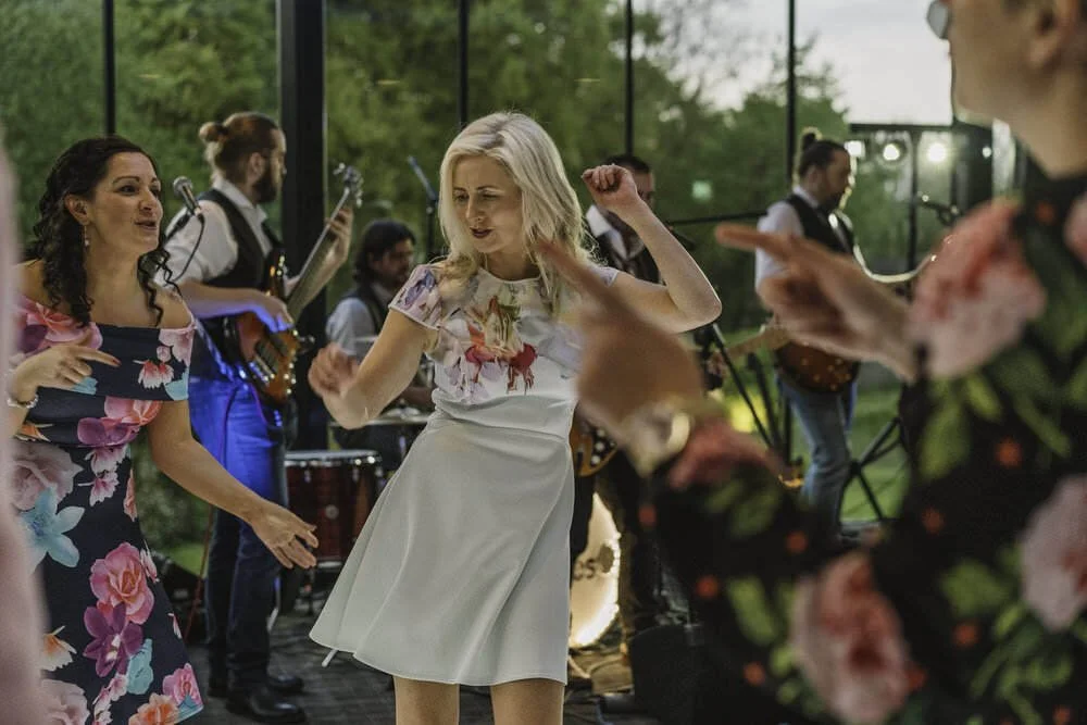 Group of wedding guests dancing happily at Fairyhill wedding venue in South Wales