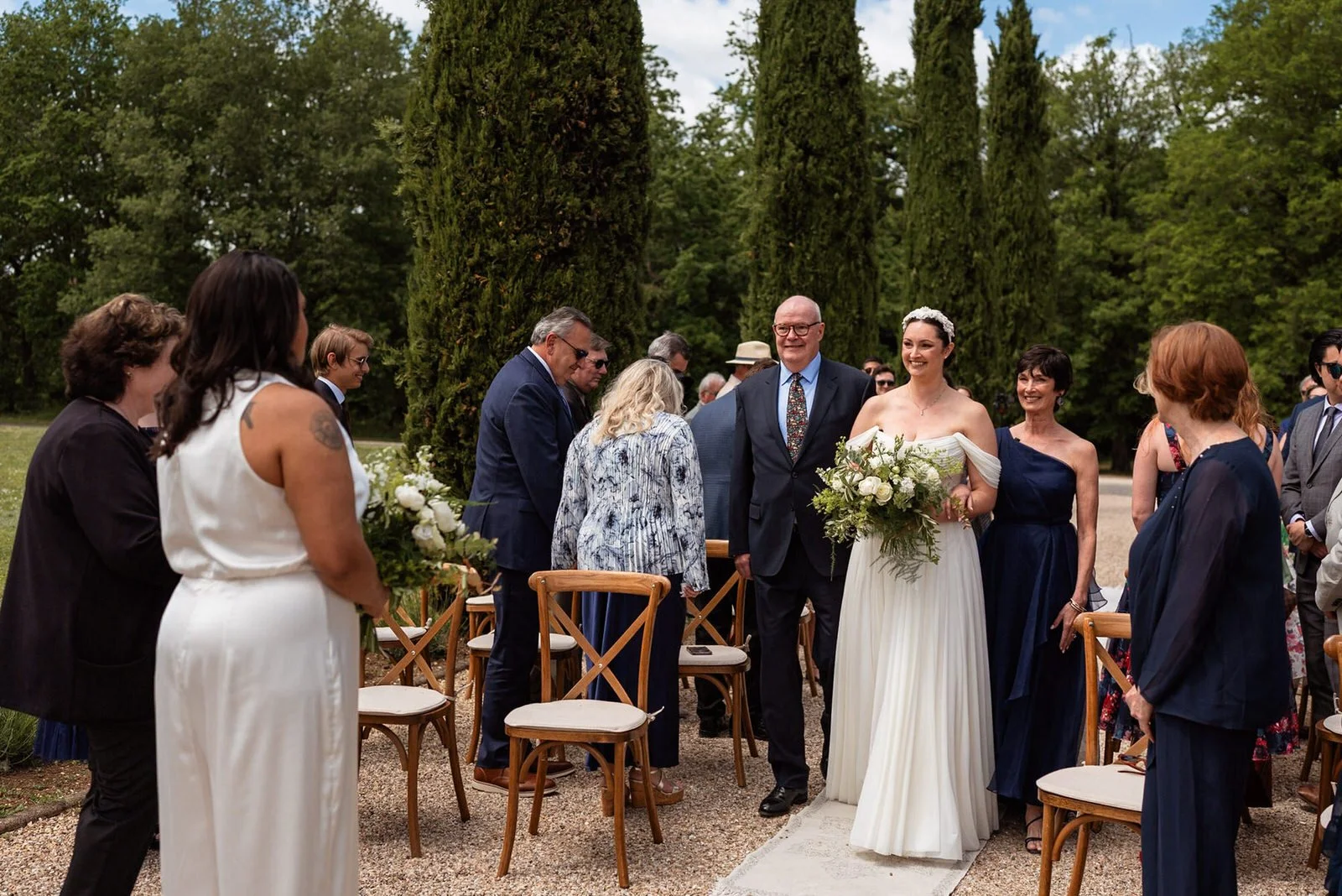 Bride walking down the aisle outside at the Chateau De Sanse.