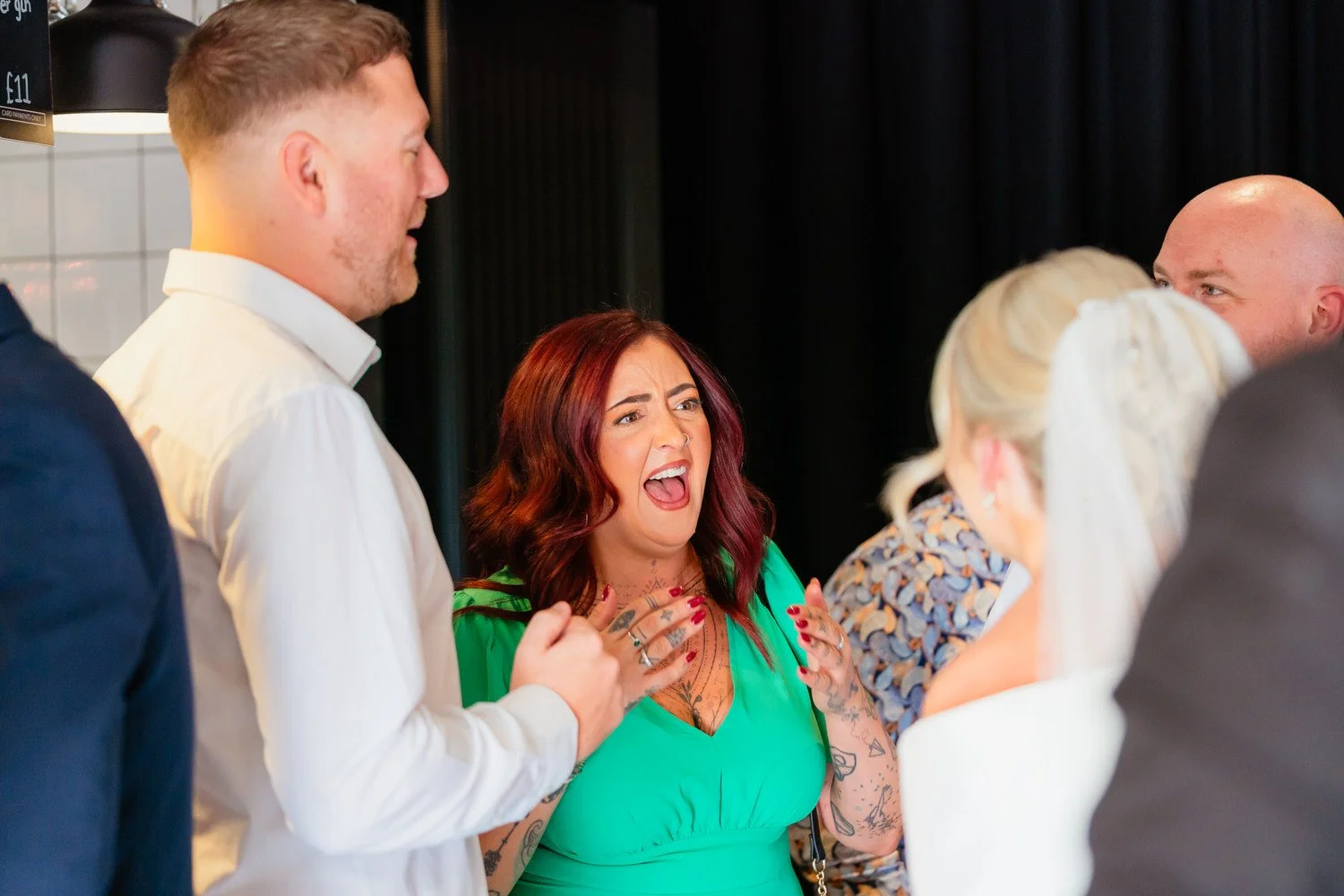 Wedding guest inside the Shack Revolution, in full character, talking to other guests.
