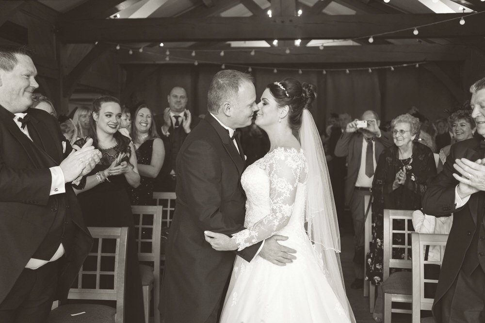 Swansea wedding couple having their first kiss as husband and wife during their ceremony at The King Arthur Hotel in Swansea