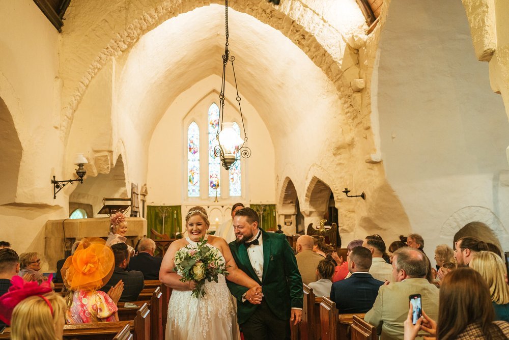 Bride and groom walking down aisle