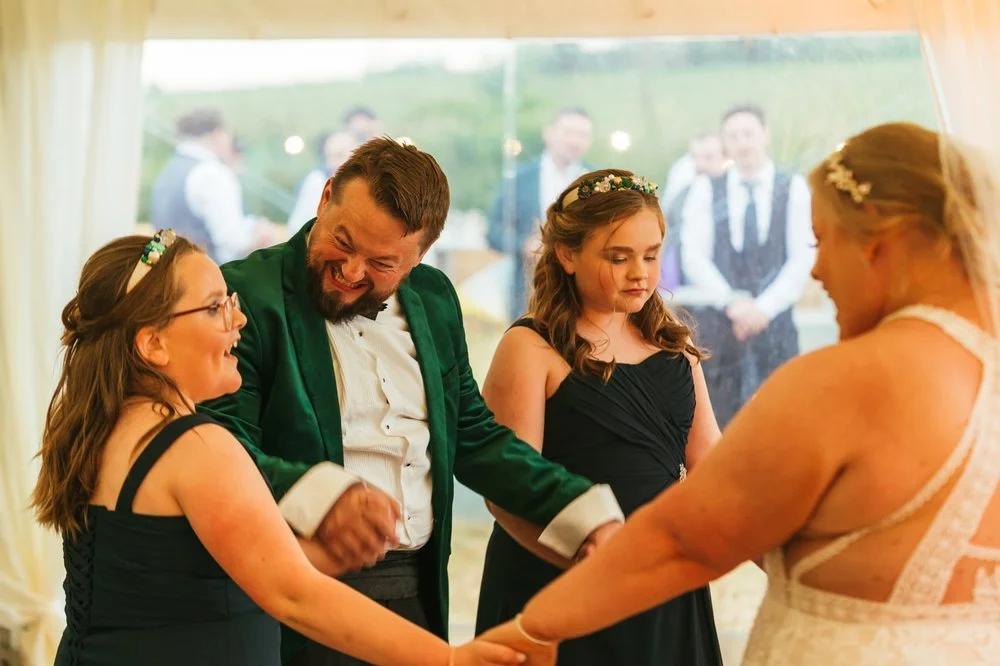 Bride and groom dancing with bridesmaids.