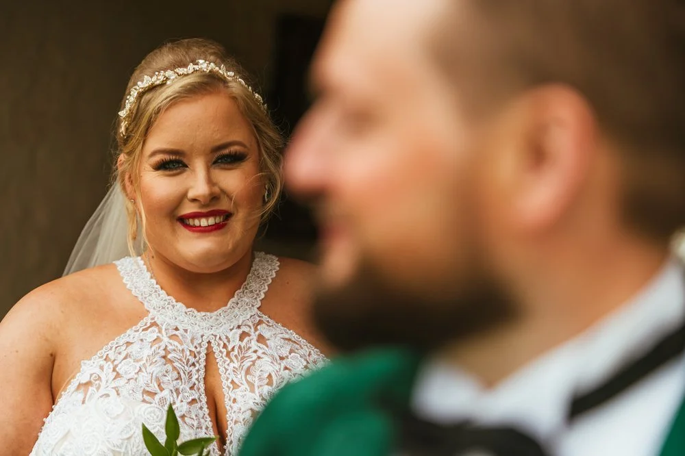 Groom close up with bride 