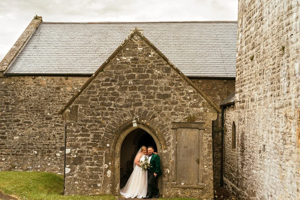 Wedding couple in St Florence church archway