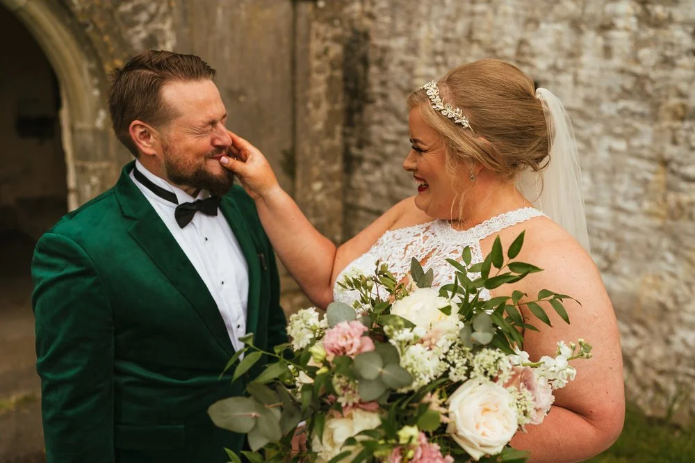 Bride wiping lipstick off groom