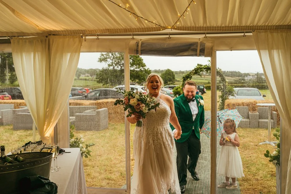 Bride and groom enter marquee.