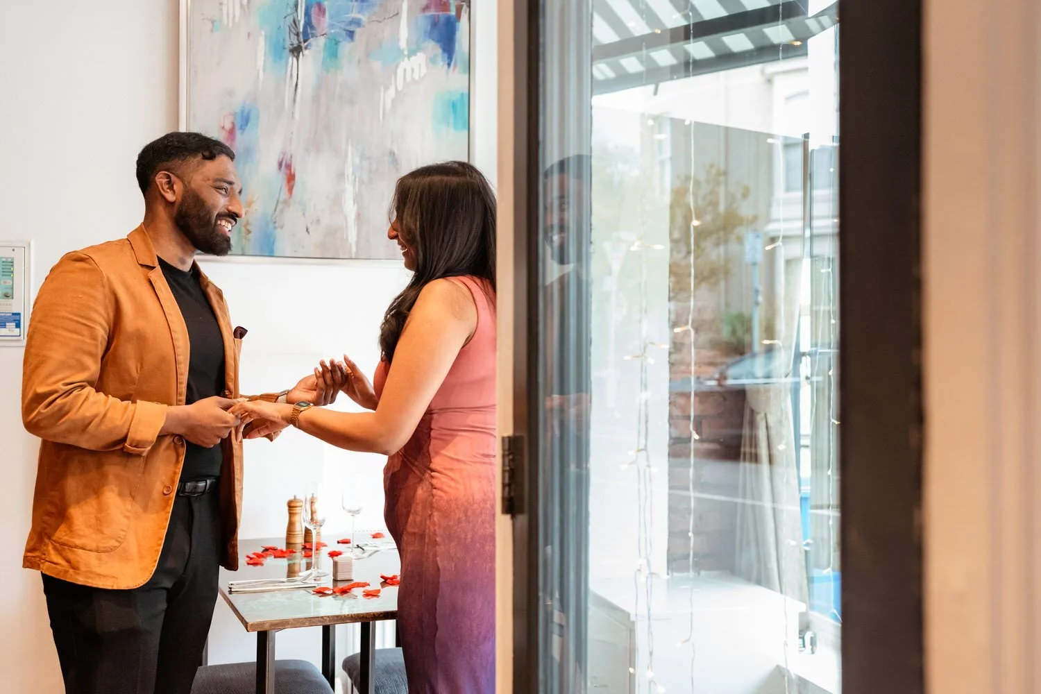 Proposal photography in Swansea, a man and woman smiling after getting engaged in Truffles restaurant.