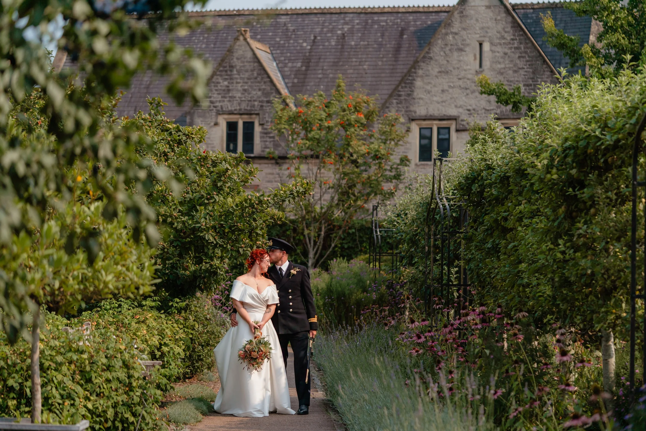 wedding couple in the pyshic gardens in Cowbridge, South Wales in a relaxed wedding moment