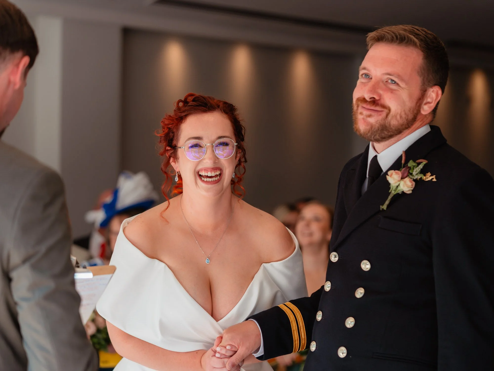 Happy wedding couple captured naturally during their wedding ceremony at the Bear Hotel in Cowbridge. Royal Navy wedding.
