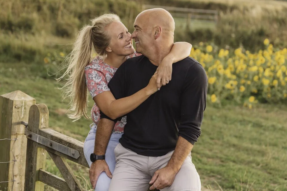 Engaged couple during their pre wedding photo session at the Rhossili sunflowers
