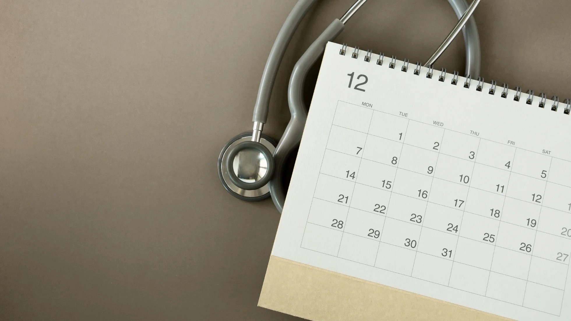 Calendar and stethoscope on a desk for contacting WE Cardiology and booking an appointment in London