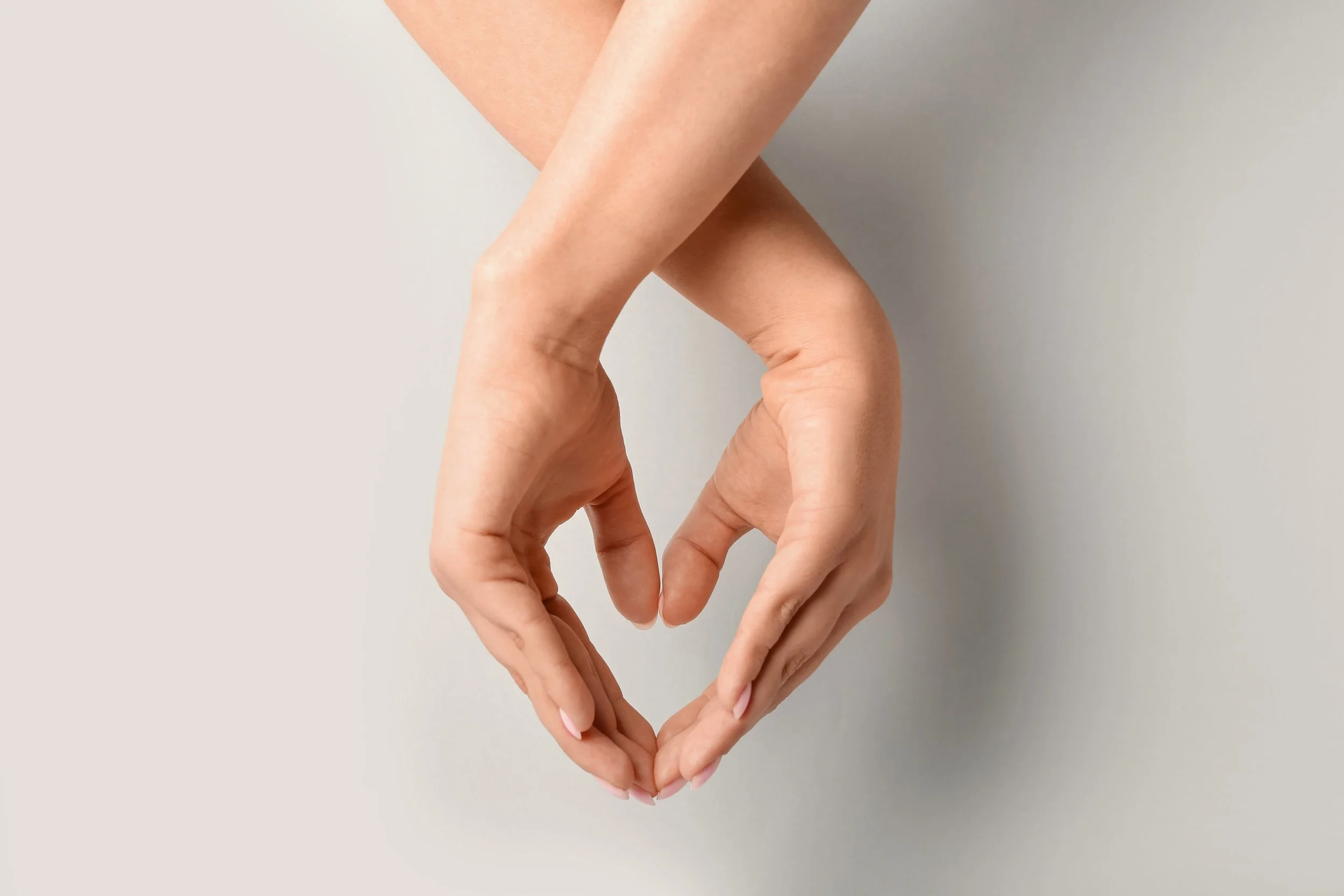 Hands forming a heart shape representing heart health and patient care at WE Cardiology